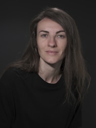 A woman with long hair and a black shirt