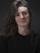 A woman with long hair and a black shirt