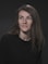 A woman with long hair and a black shirt