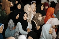 A group of women in hijabs are gathered together