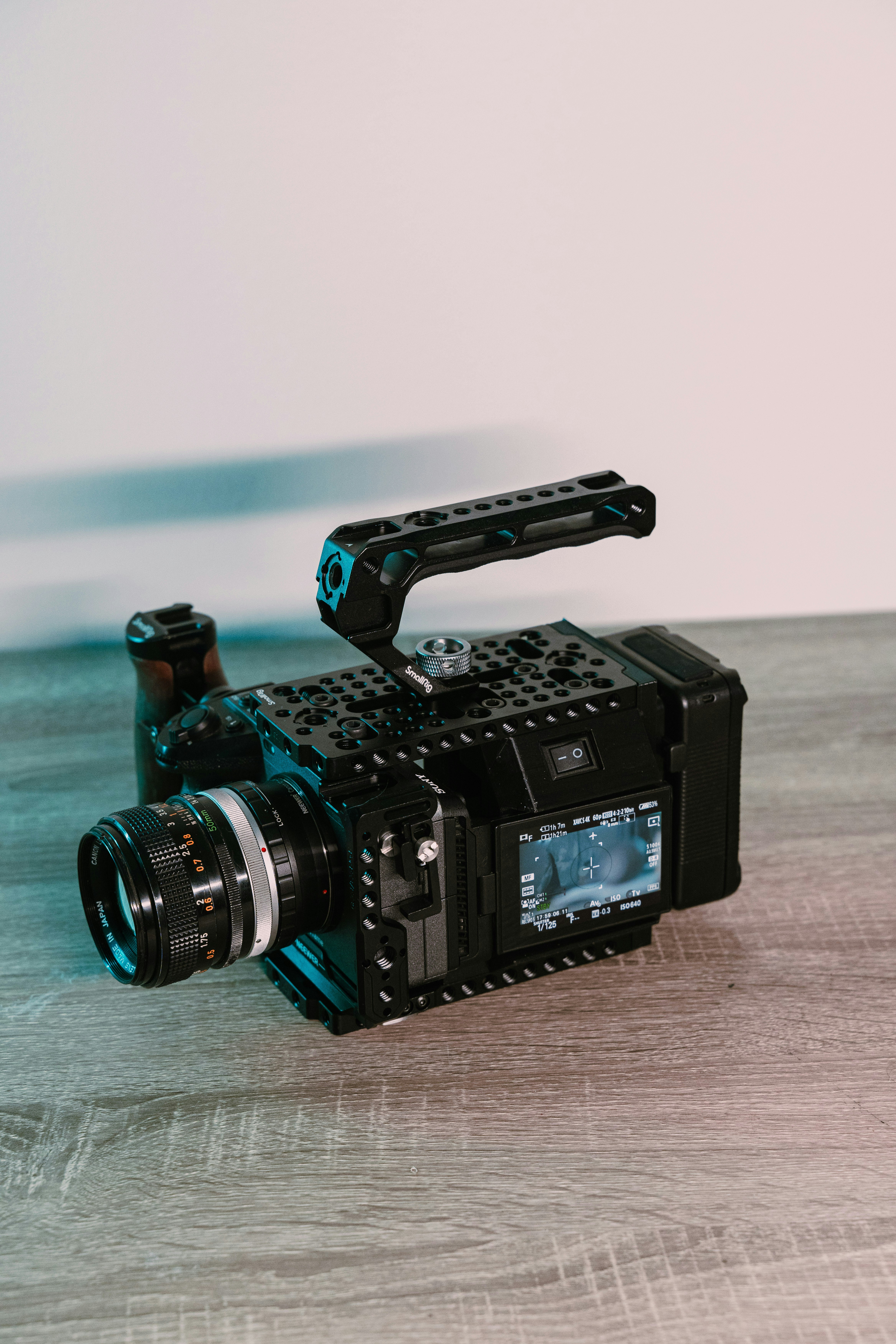 A black camera sitting on top of a wooden table