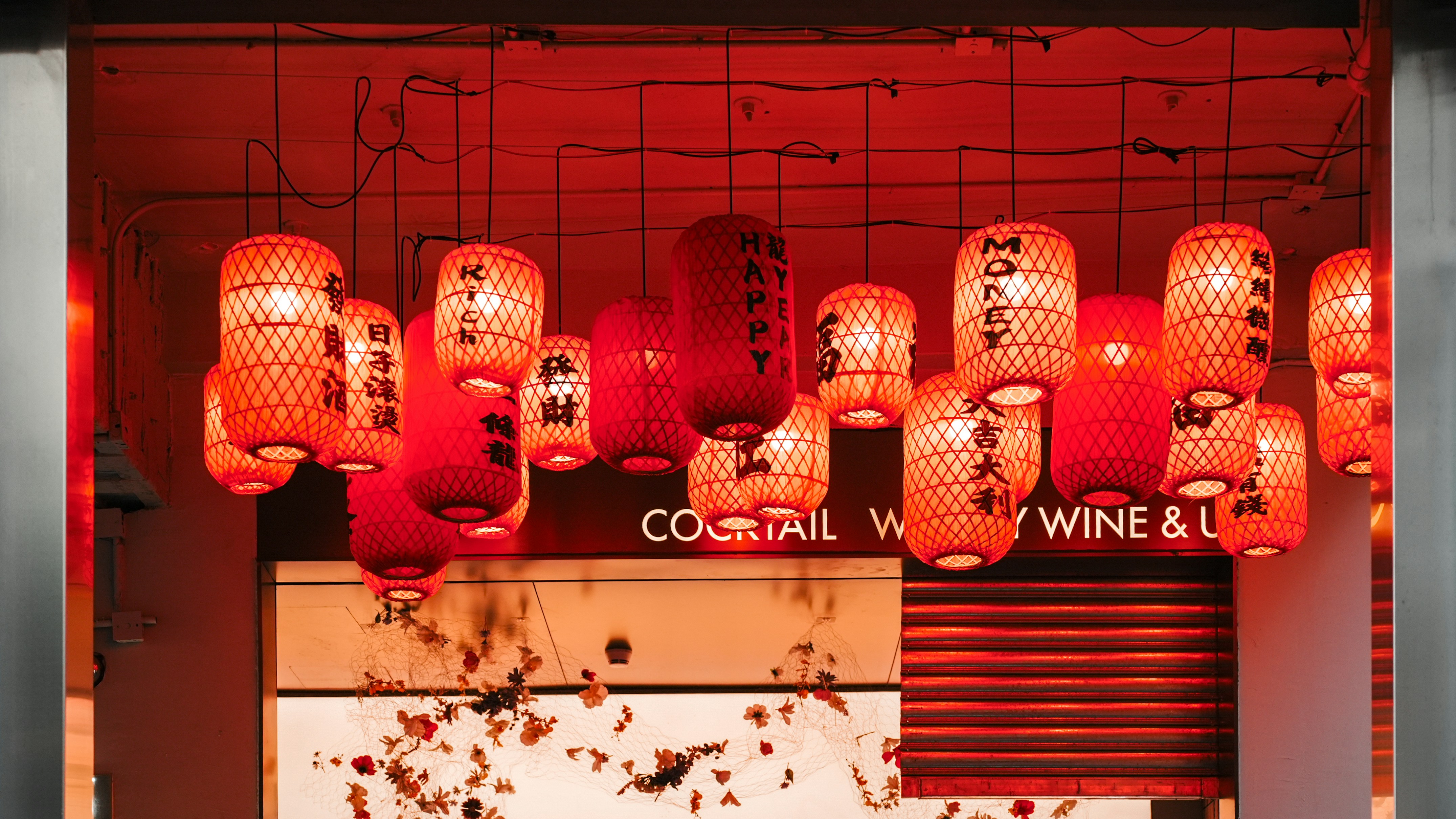 A restaurant with red lanterns hanging from the ceiling