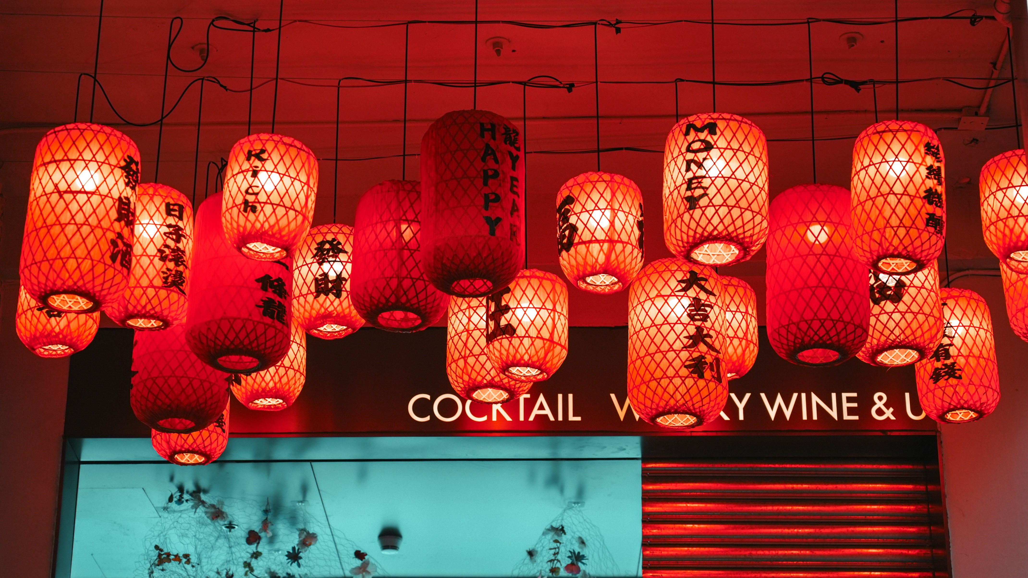 A bunch of red lanterns hanging from the ceiling