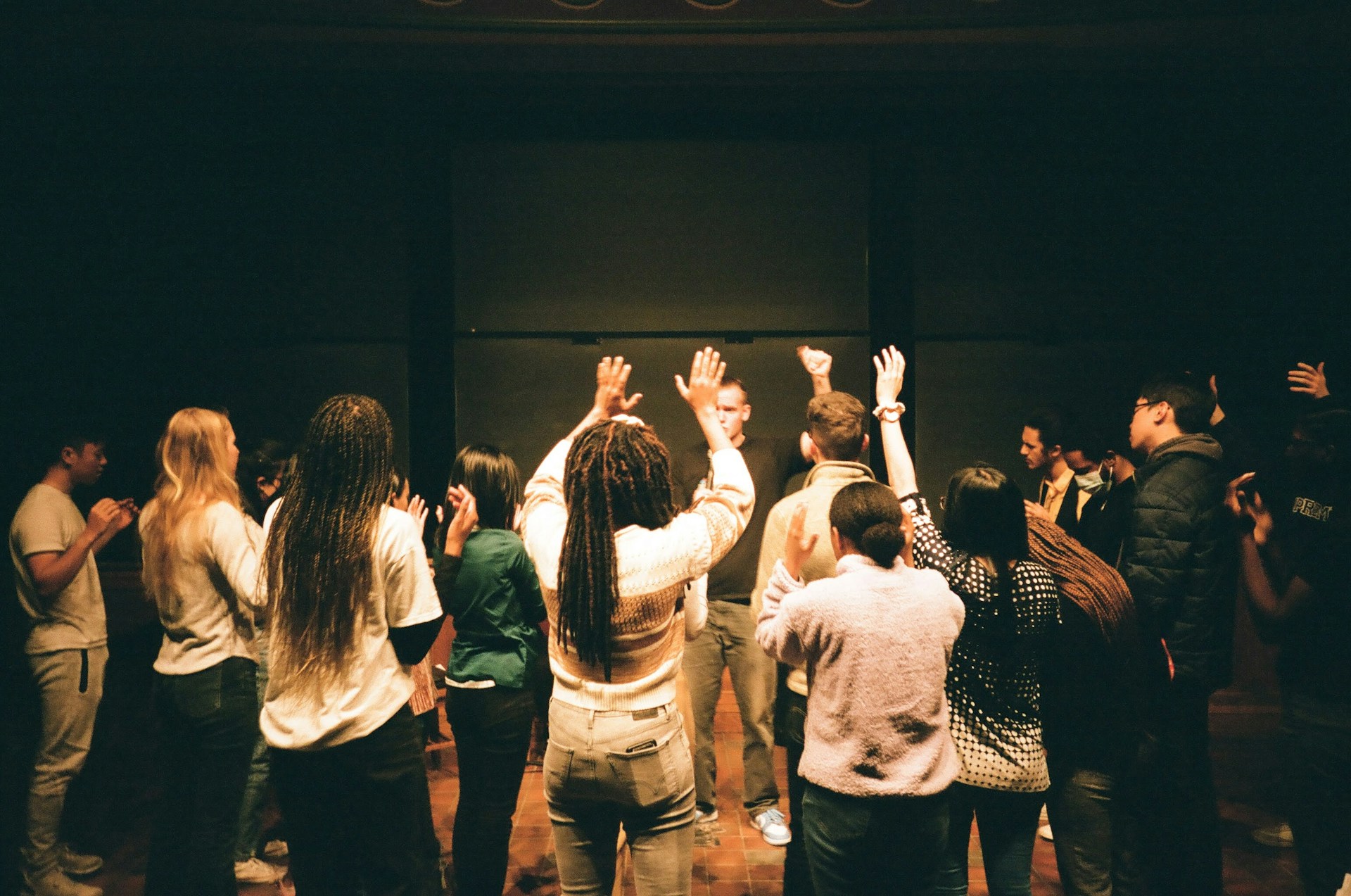 A group of people standing around each other
