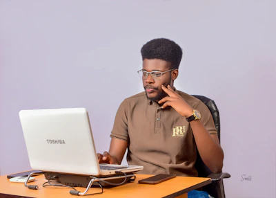 A man sitting in front of a laptop computer