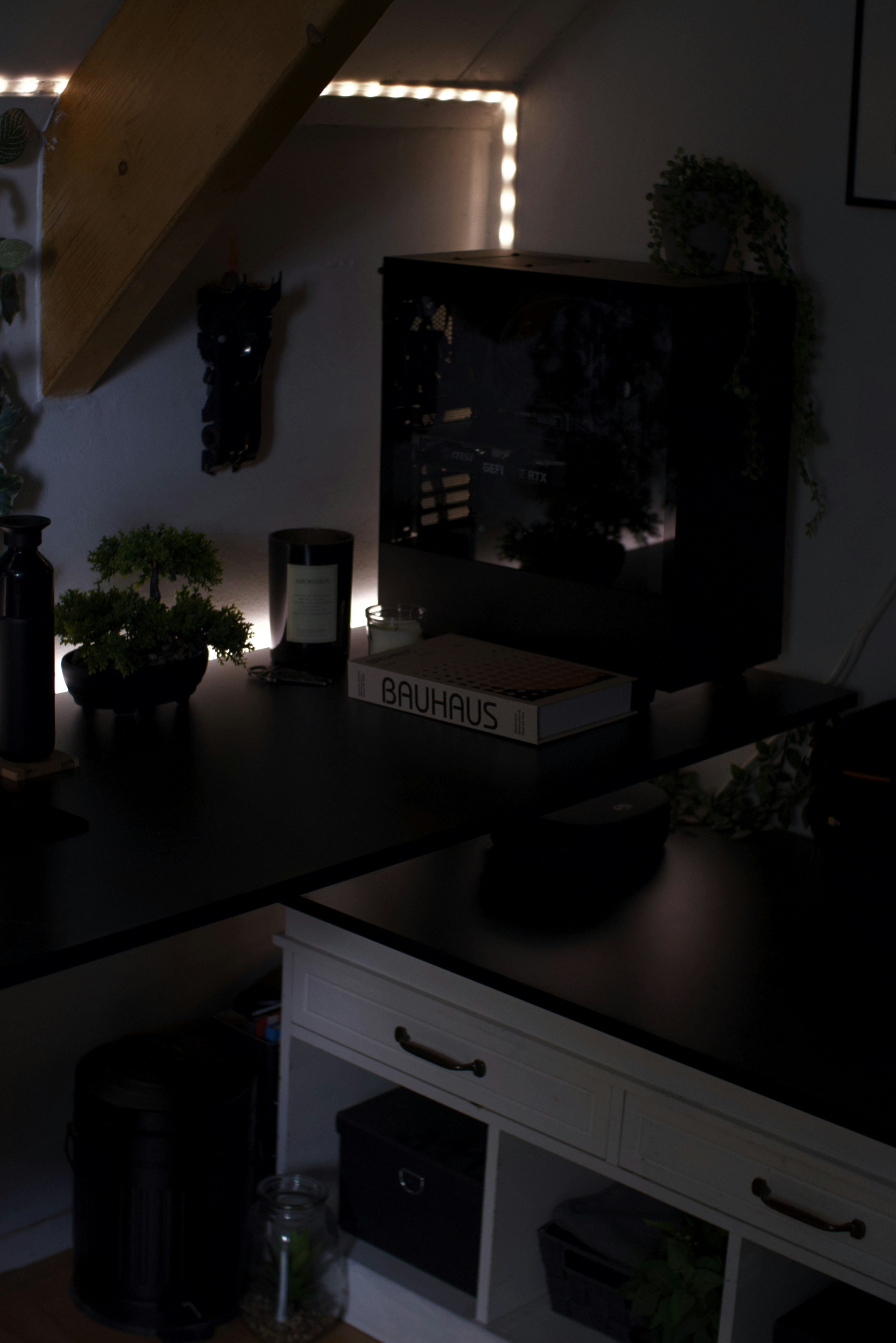 Organised notes and planning workspace on dark desk with minimal ambient lighting