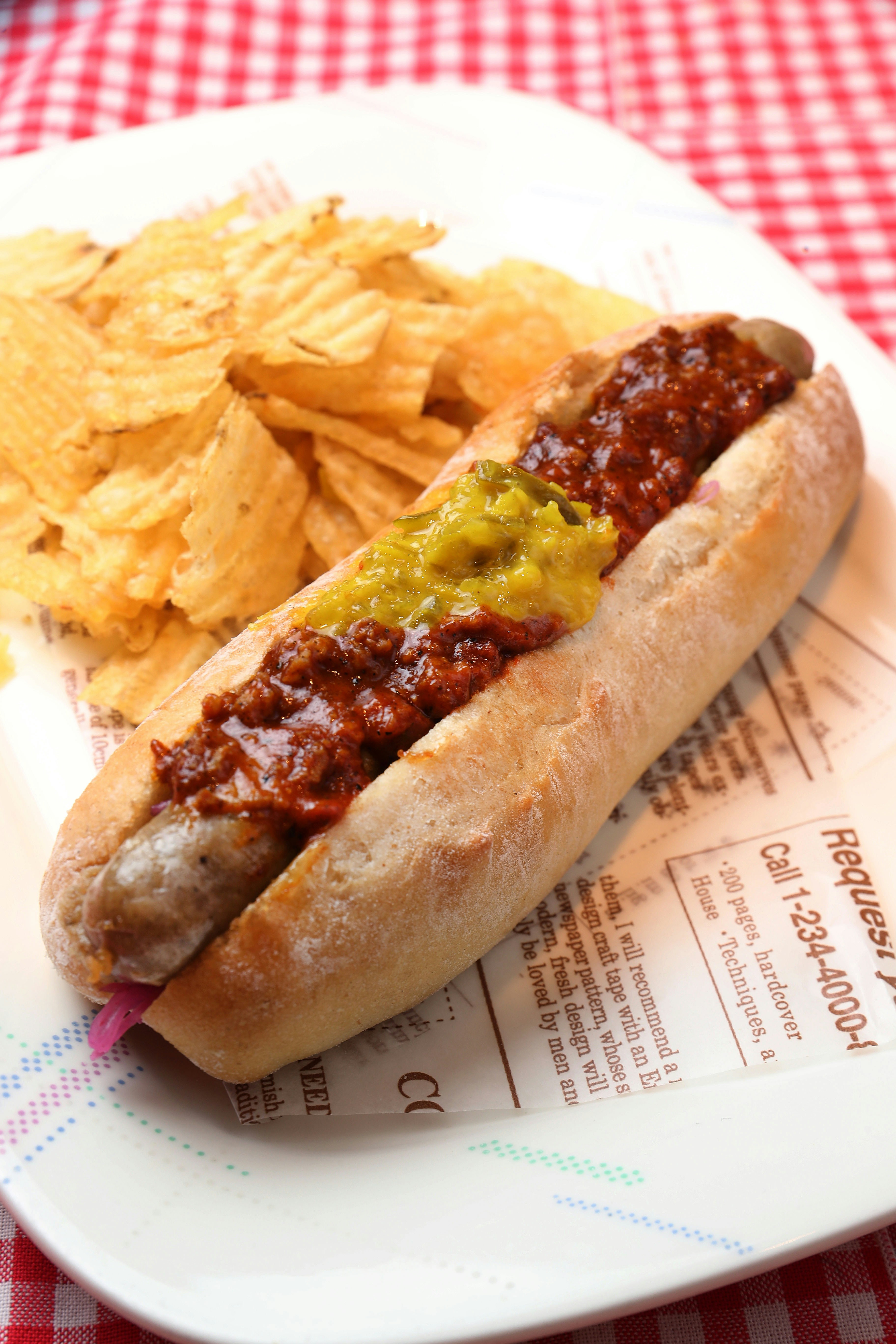 A chili dog and chips on a plate