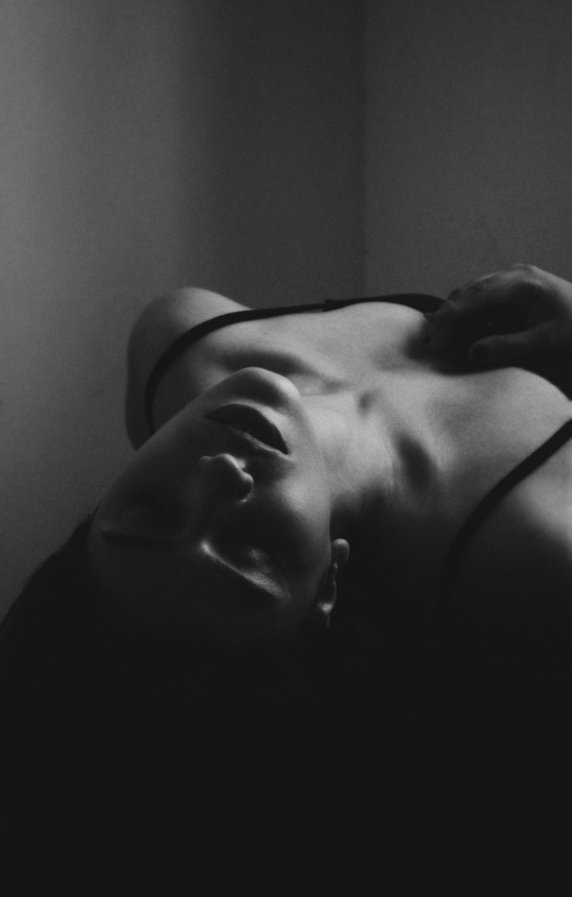 A black and white photo of a woman laying down