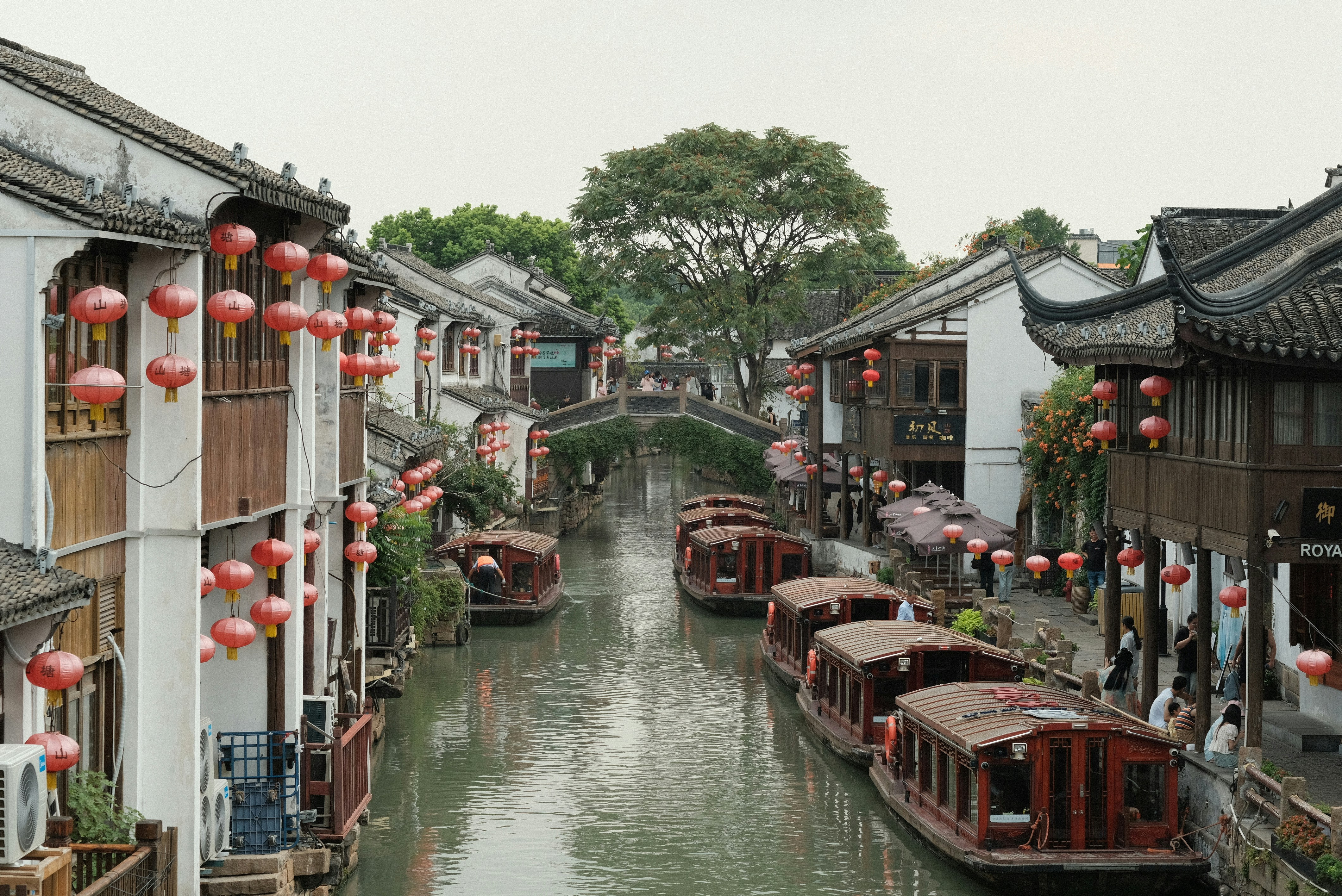 A canal filled with lots of boats next to buildings