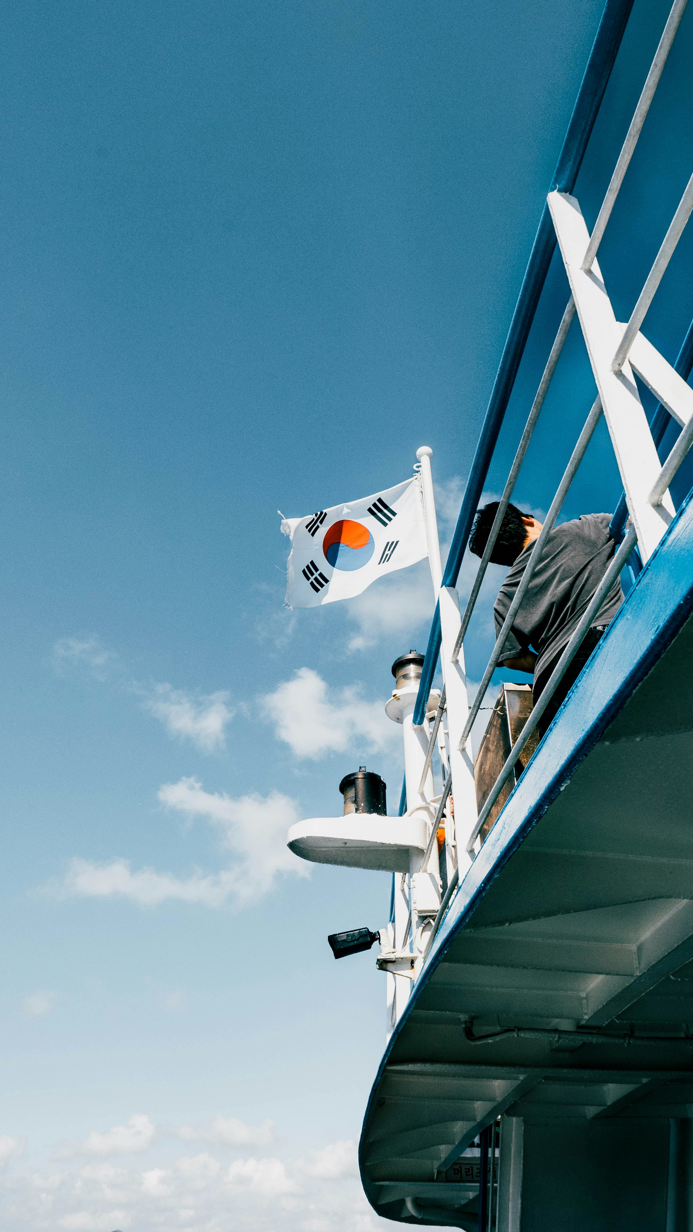 A man standing on the side of a boat