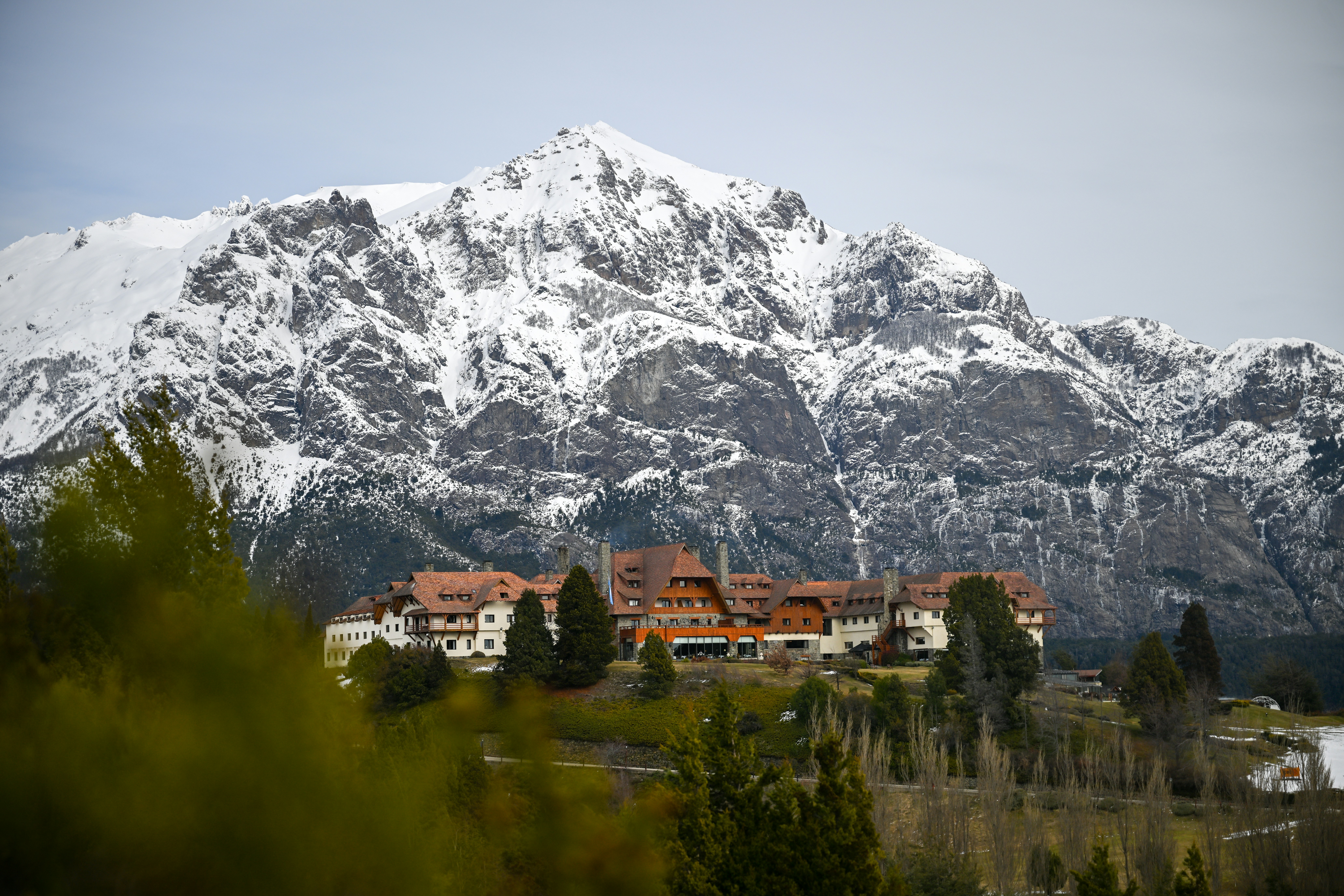A snow covered mountain with houses in the foreground