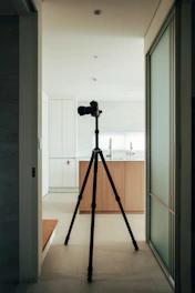 A camera on a tripod in a hallway