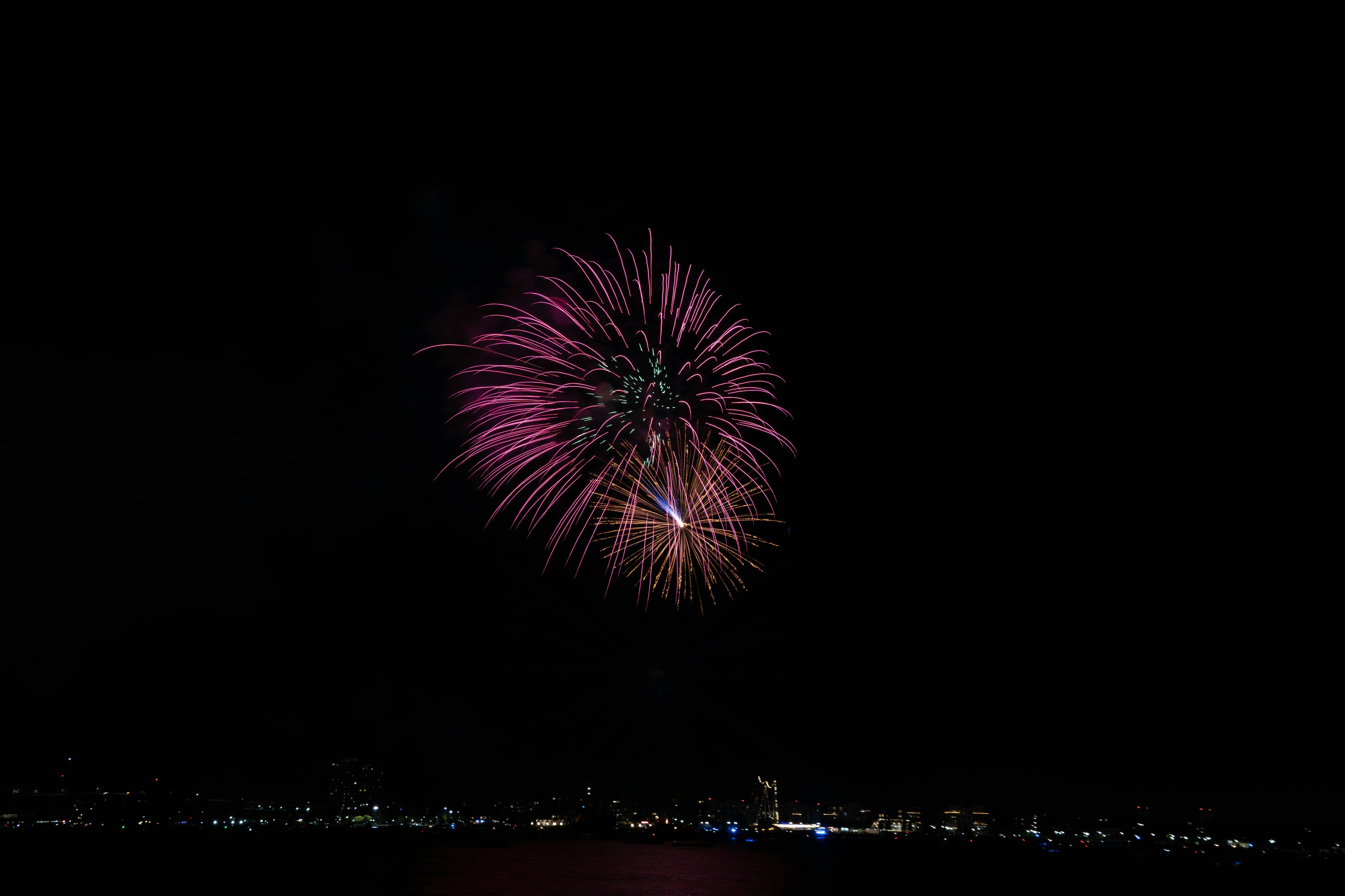 A firework display over a city at night