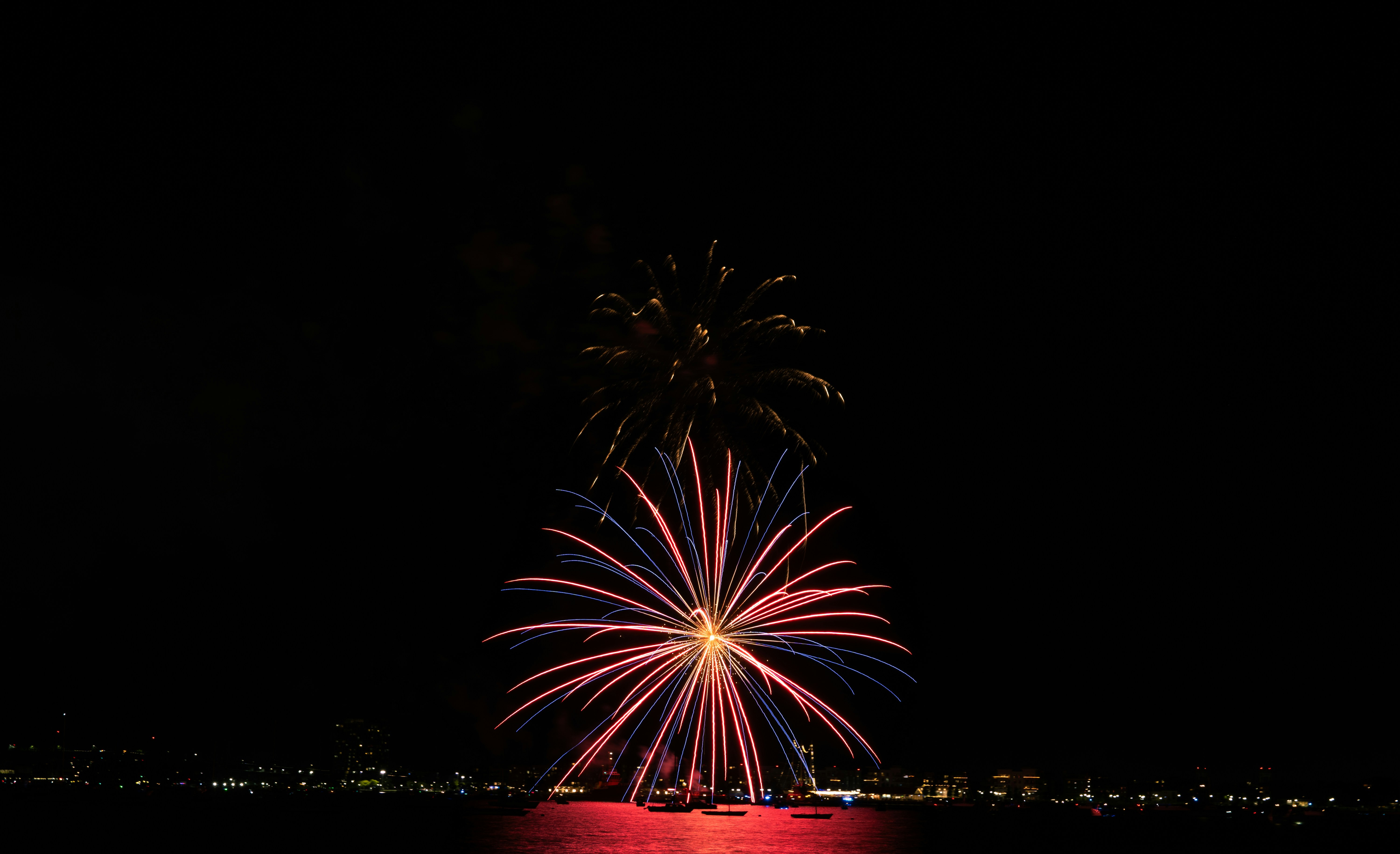 A fireworks display over a body of water