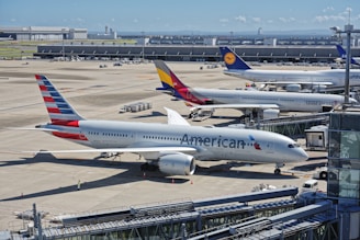 A bunch of airplanes that are on a runway