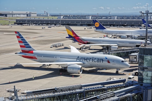 A bunch of airplanes that are on a runway