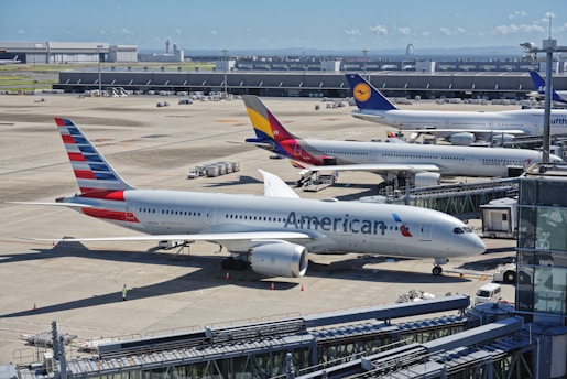 A bunch of airplanes that are on a runway