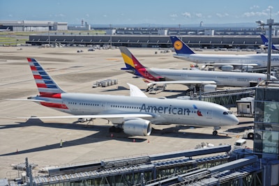 A bunch of airplanes that are on a runway