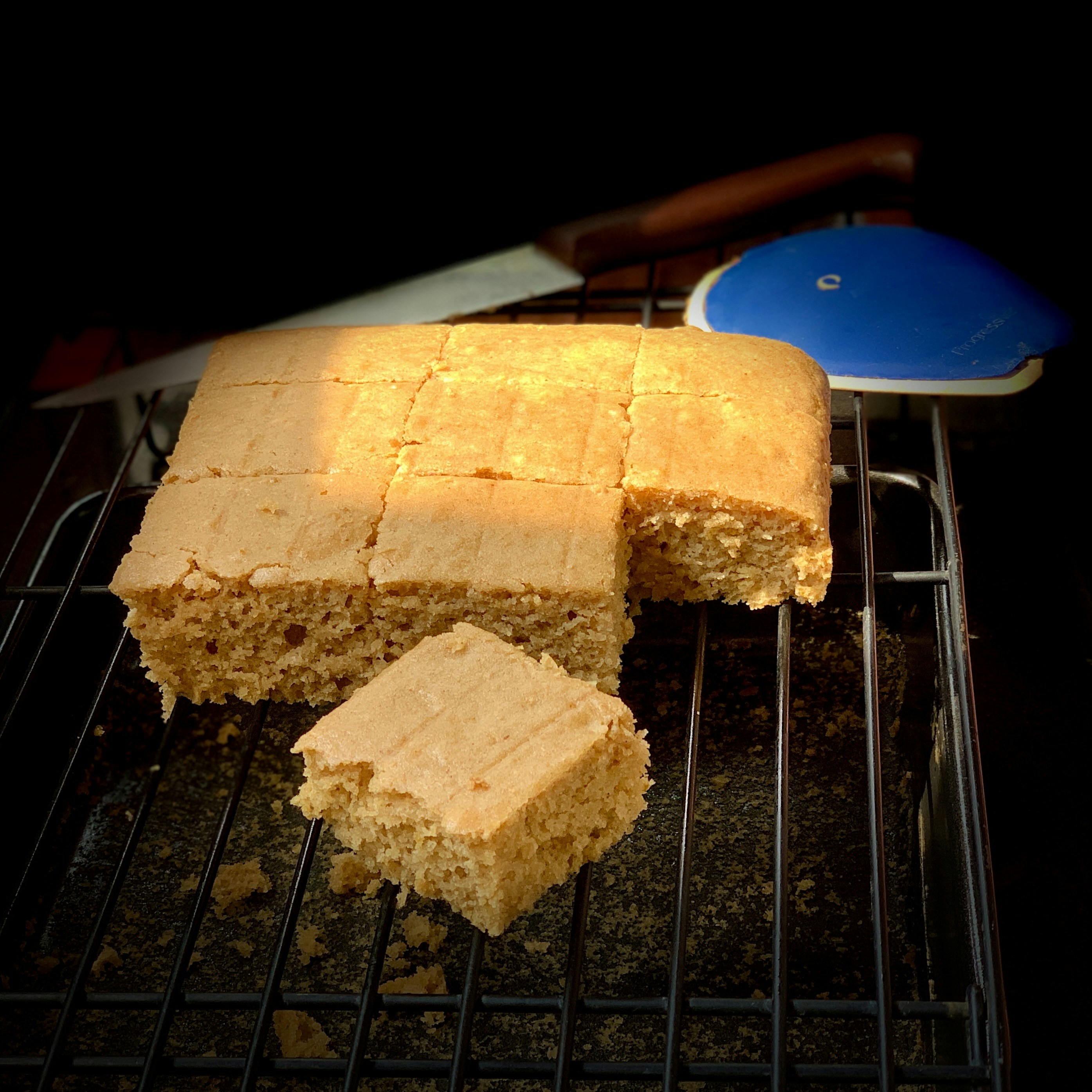 Golden sponge cake layers cooling on a wire rack with a perfectly domed top and even crumb structure