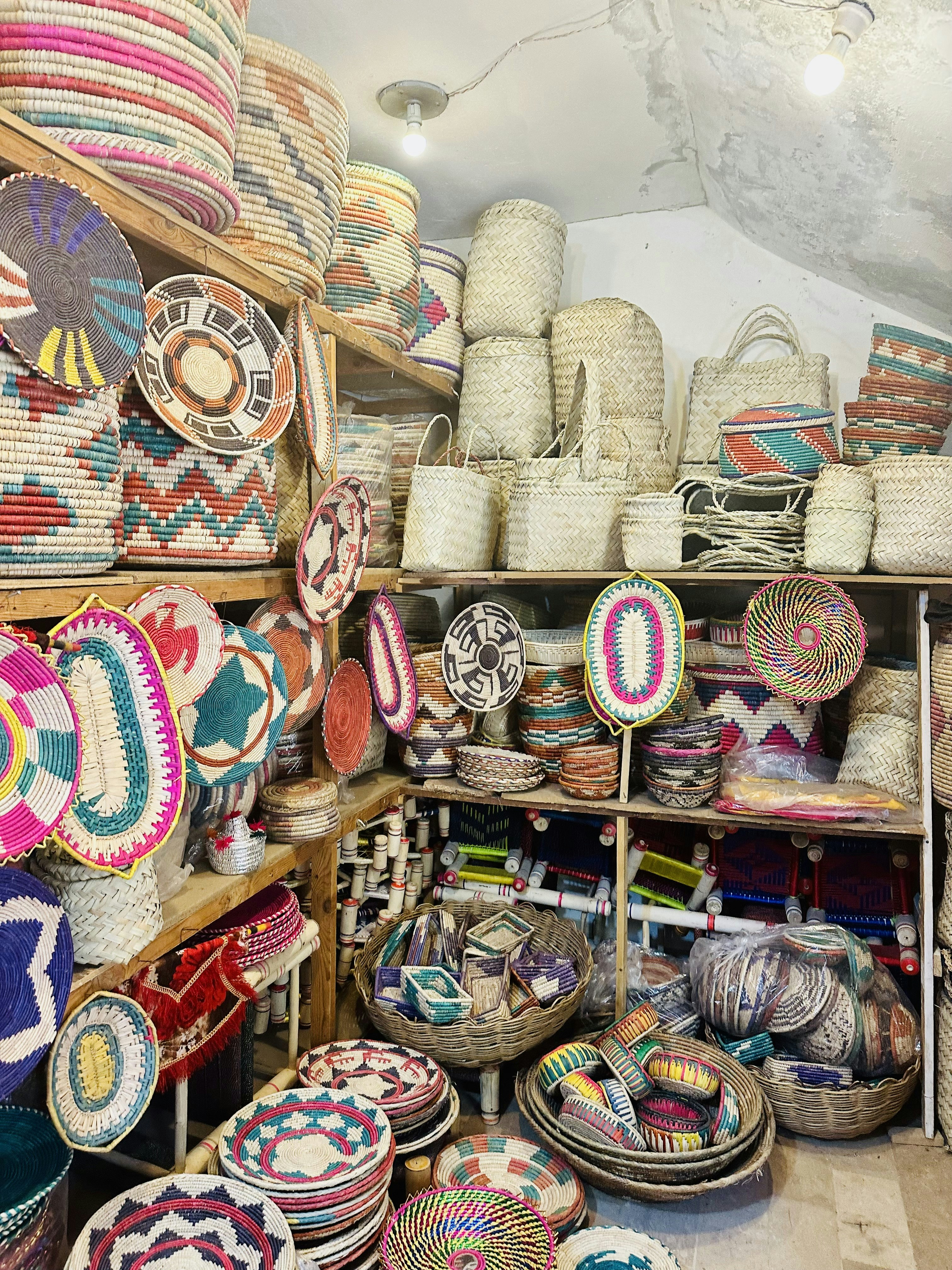 Colorful gift shop with tropical souvenirs, woven baskets, and handcrafted items on wooden shelves
