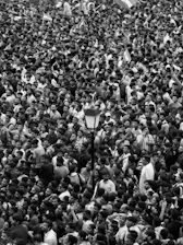 A large crowd of people standing around each other