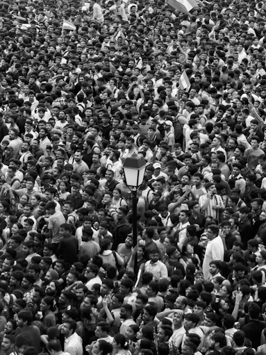 A large crowd of people standing around each other