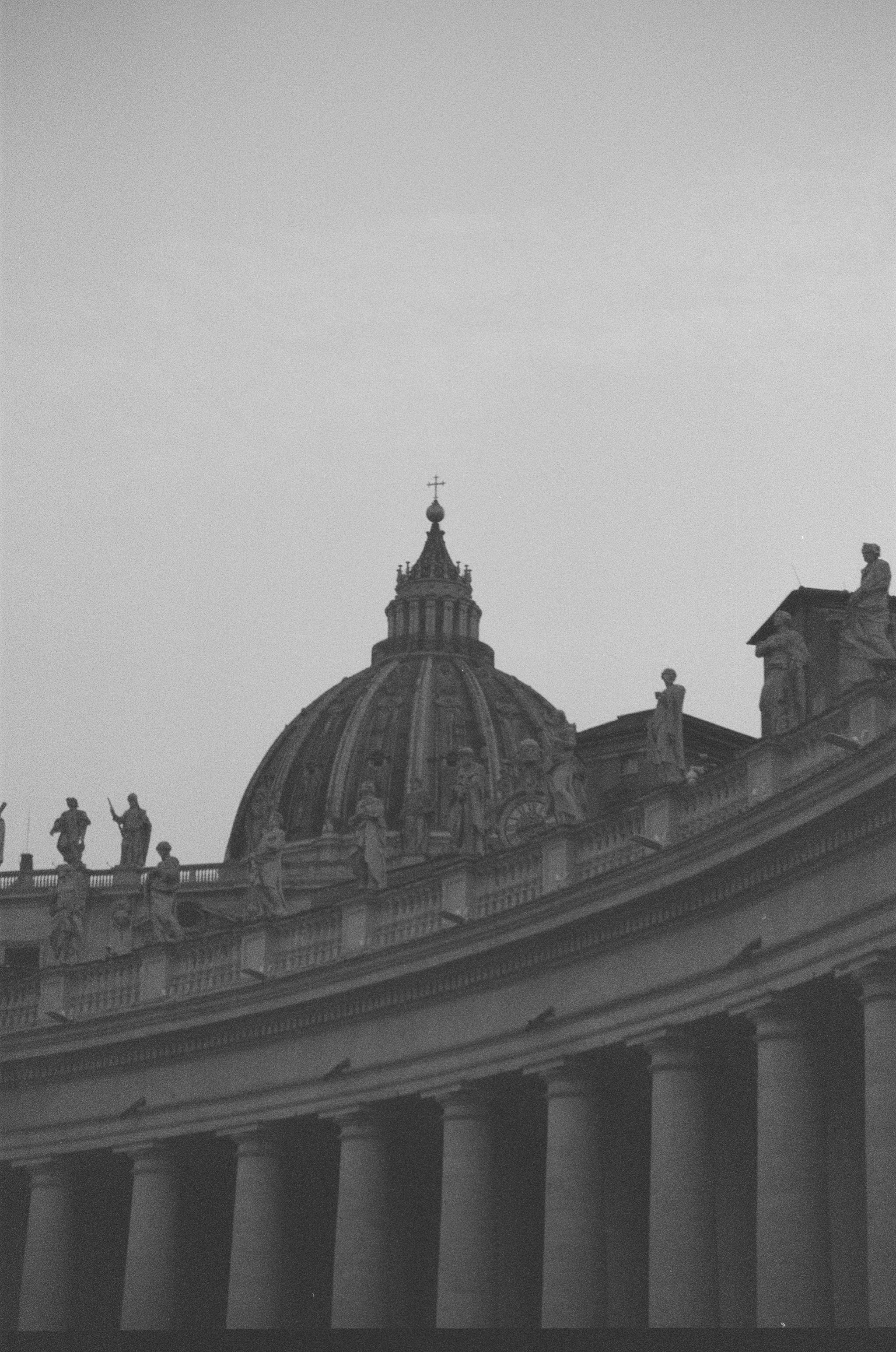 A black and white photo of a building with a dome