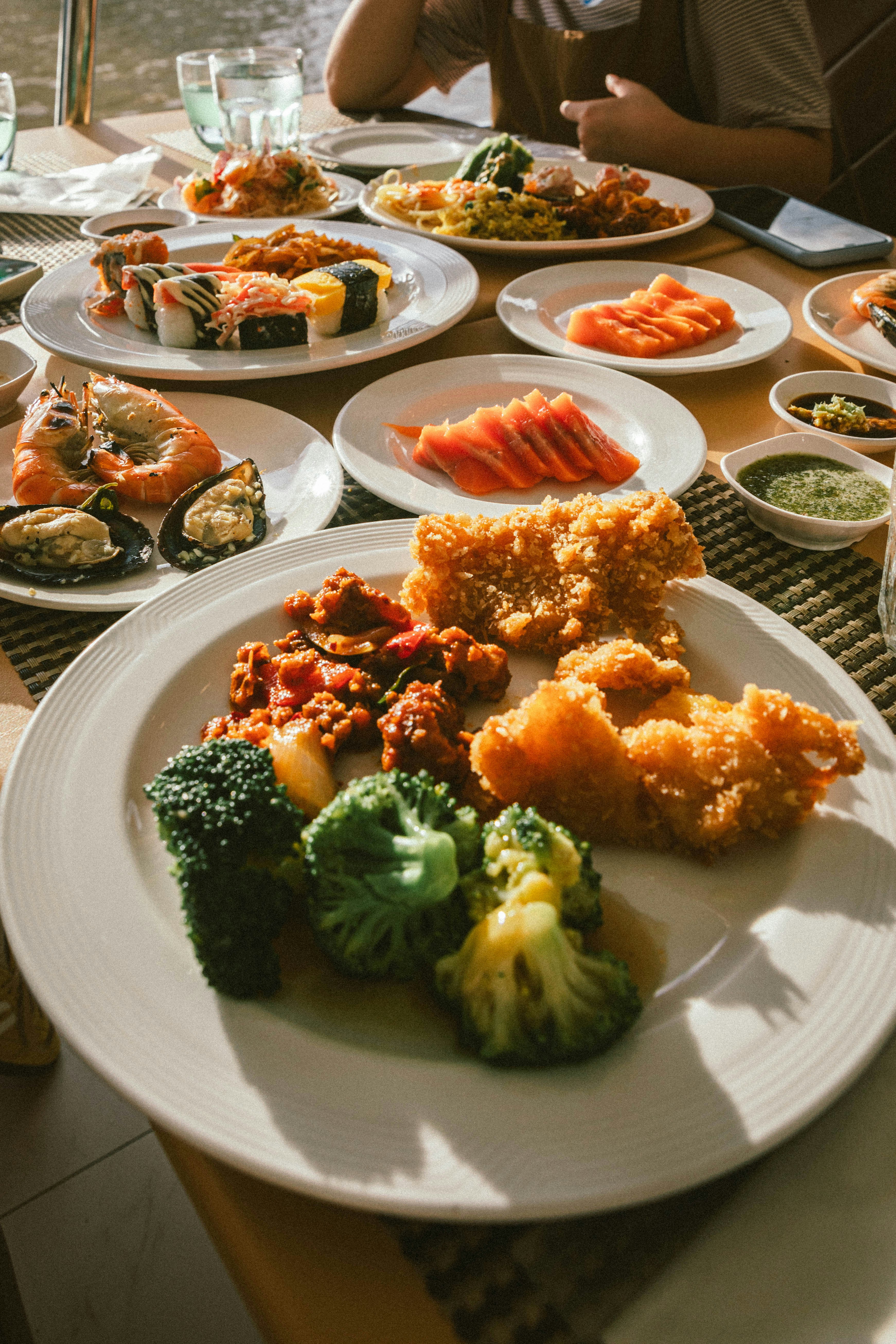 A group of people sitting at a table with plates of food