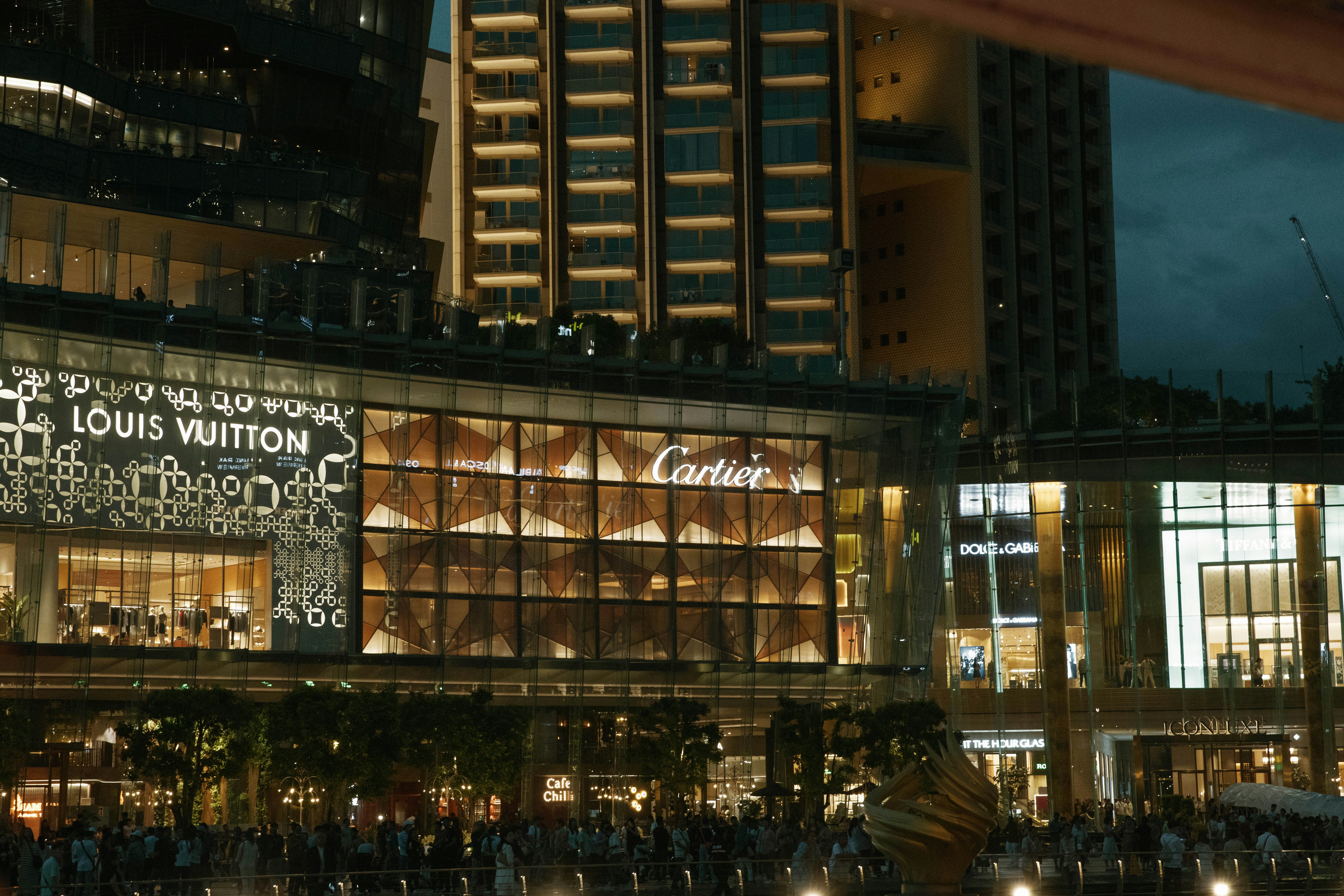 A group of people standing outside of a building at night