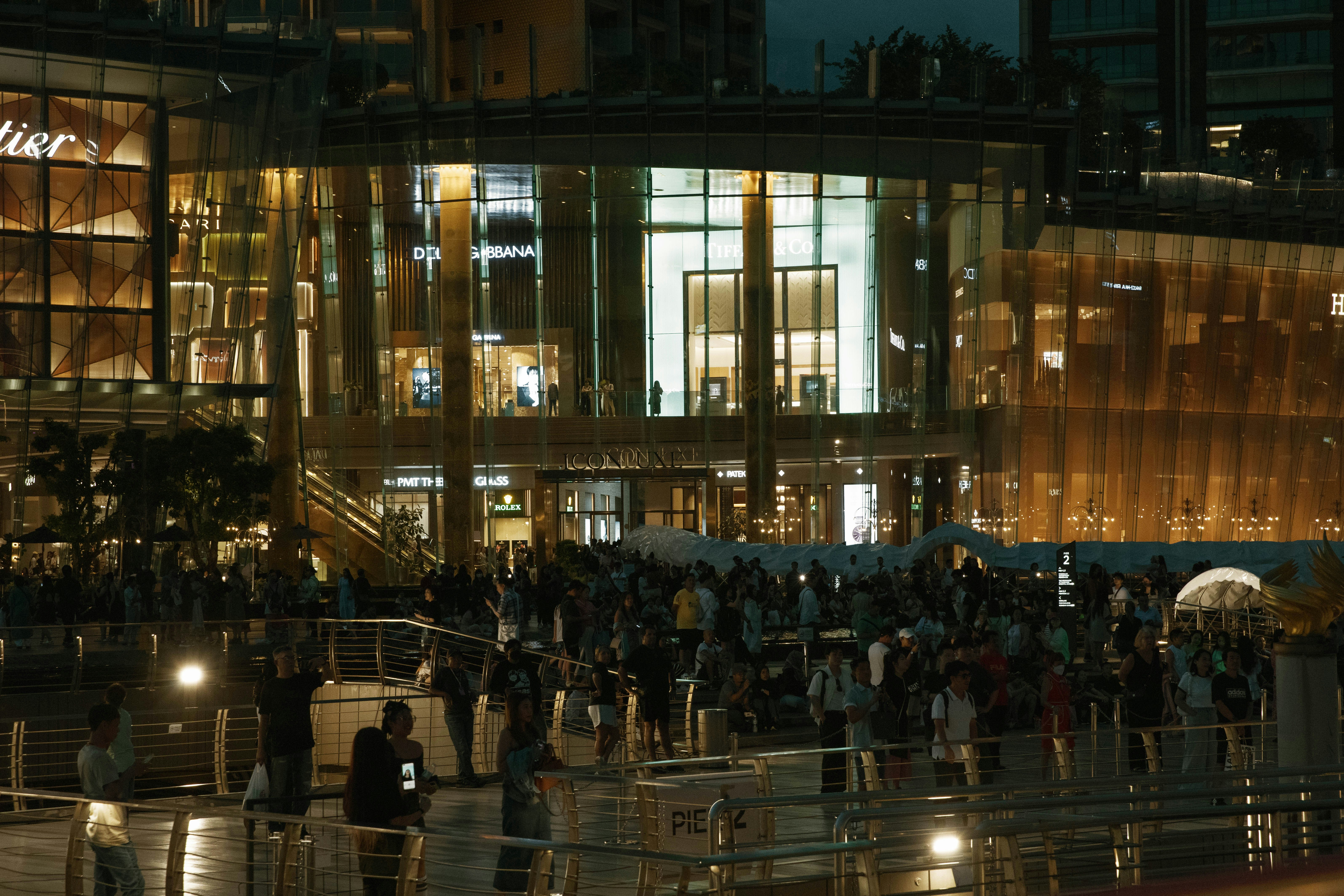 A group of people standing outside of a building at night