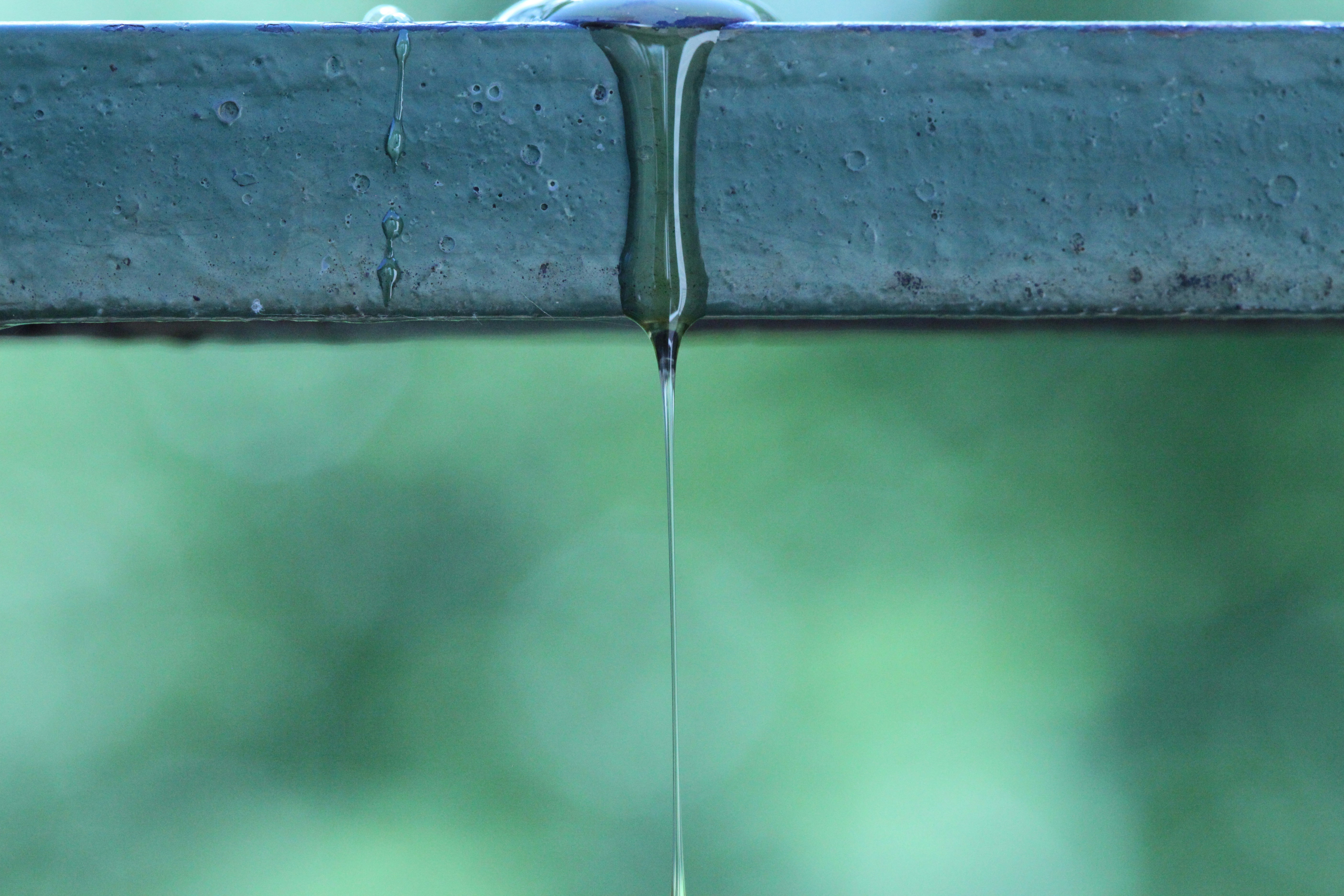 A close up of water dripping from a faucet