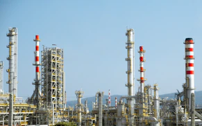 A factory with a lot of red and white pipes