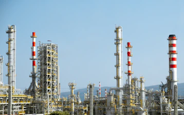 A factory with a lot of red and white pipes