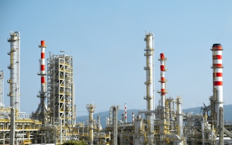 A factory with a lot of red and white pipes