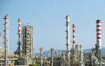 A factory with a lot of red and white pipes