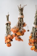 A bunch of dried flowers hanging from a ceiling