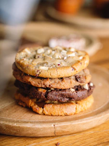 A stack of cookies sitting on top of a wooden plate