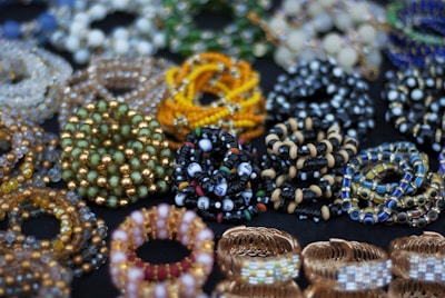A table topped with lots of different types of bracelets
