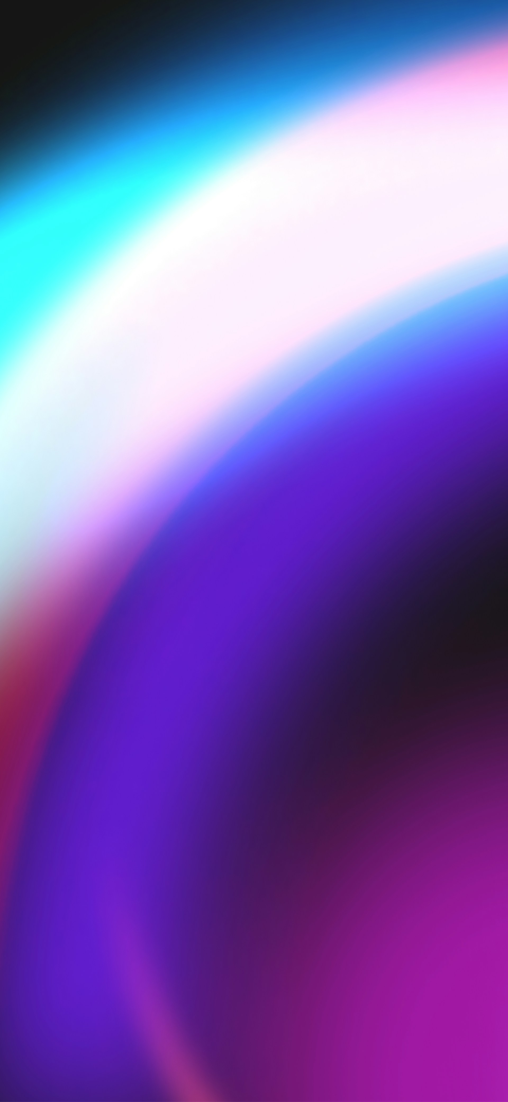 A blurry image of a rainbow colored background