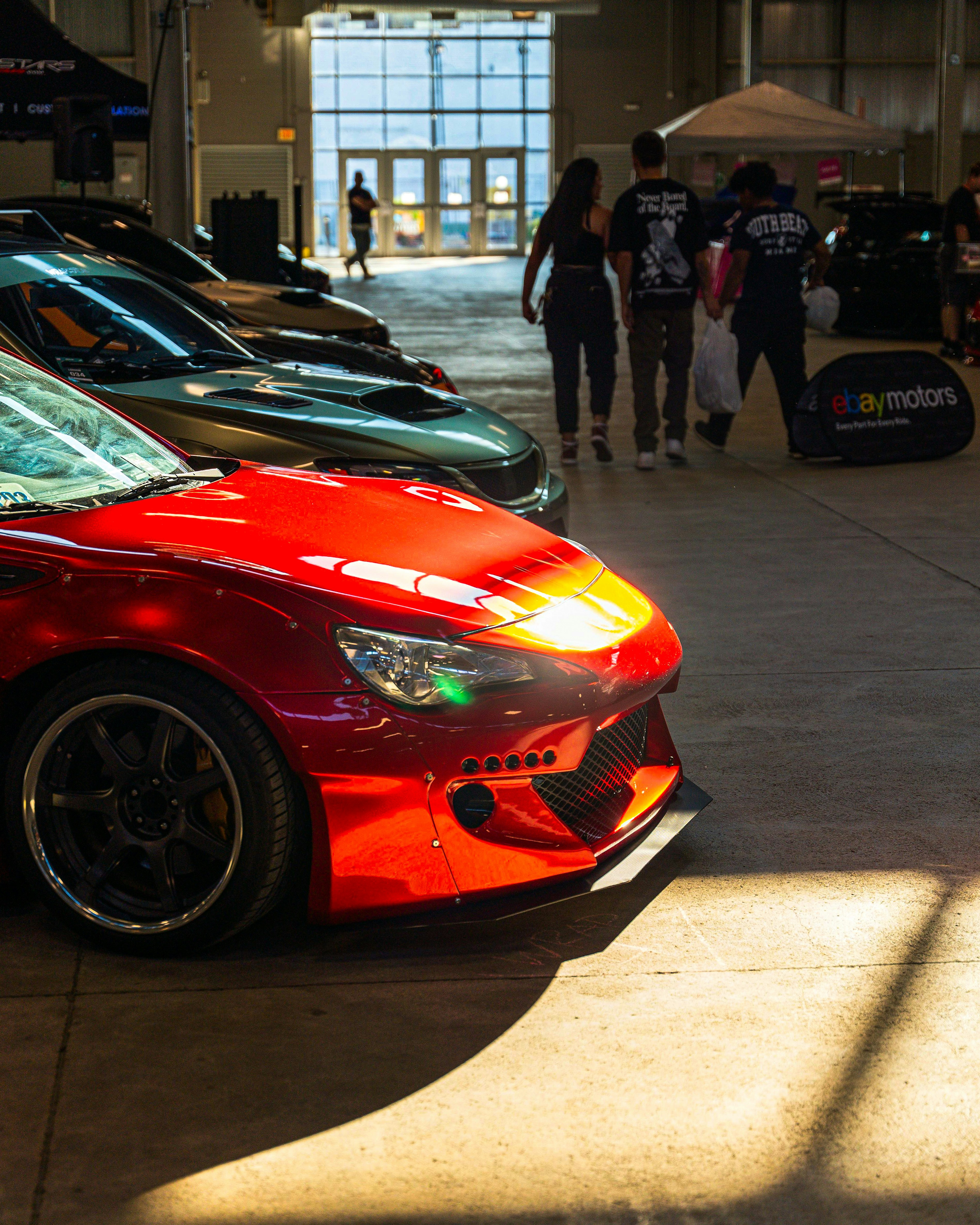 A red sports car parked in a parking garage