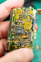 A close up of a person holding a small electronic device