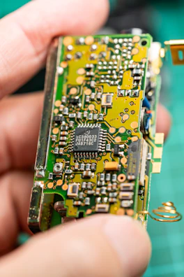 A close up of a person holding a small electronic device