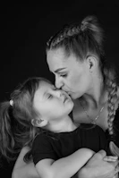 A woman holding a little girl in her arms