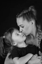 A woman holding a little girl in her arms