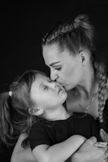 A woman holding a little girl in her arms