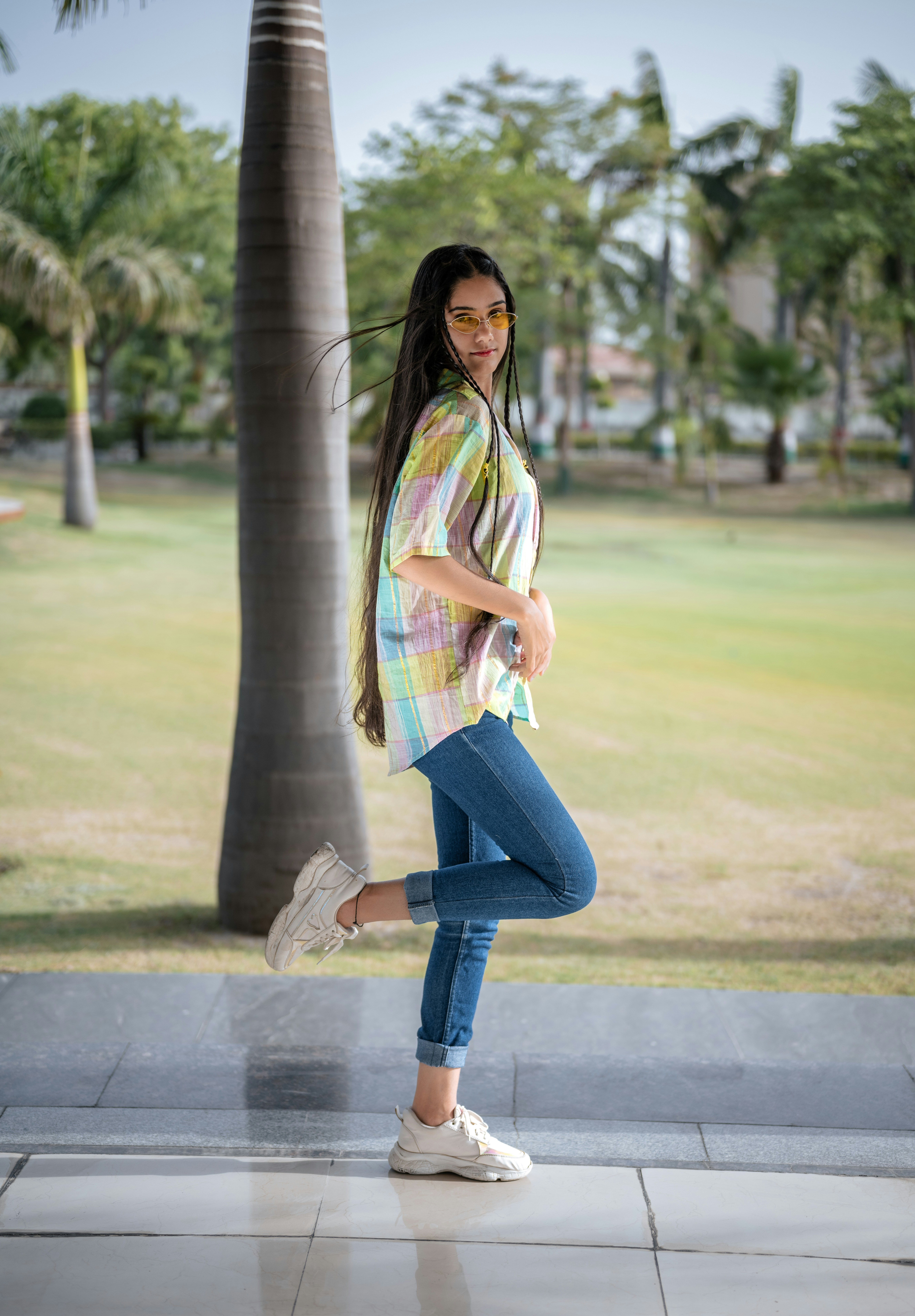 A woman standing in front of a palm tree photo – Free Female Image on ...