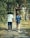 A couple of people walking down a sidewalk