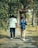 A couple of people walking down a sidewalk