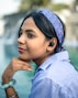 A woman wearing a blue shirt and a headband