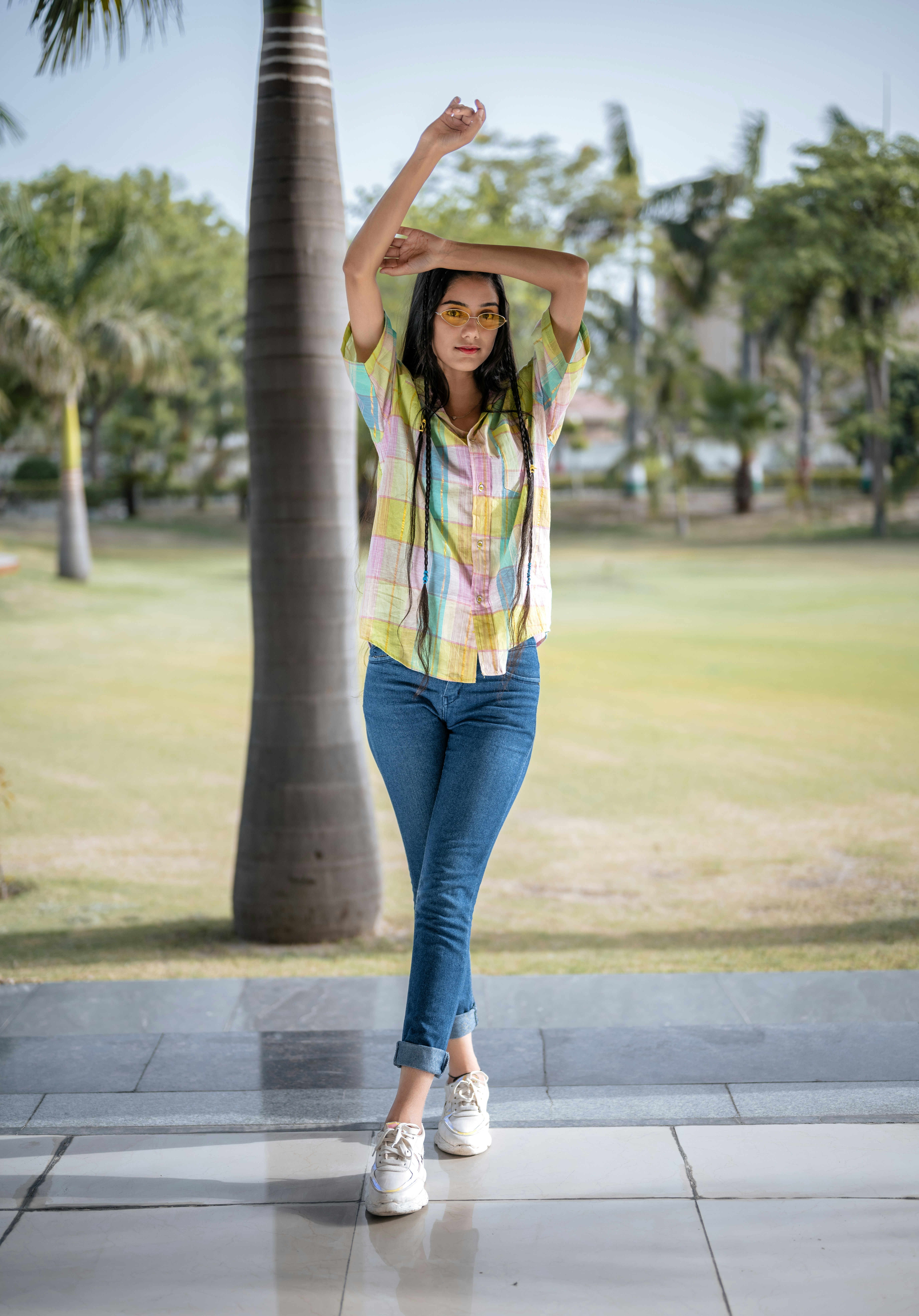 A woman standing in front of a palm tree photo – Free Girl Image on ...